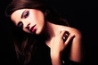 brunette girl posing in studio on dark background