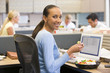 Photo: Businesswoman in cubicle with laptop eating salad Businesswoman in cubicle with laptop eating salad