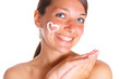 Photo of the woman with cream heart on the face