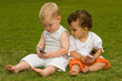 Photo: Two kids playing in the park with their parents' mobile phones Two kids playing in the park with their parents' mobile phones