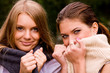 Portrait of two lovely girlfriends in summer park