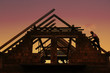 Construction worker working on house wooden roof