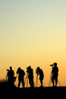Silouette of five photographers lined up shooting photos Silouette of five photographers lined up shooting photos
