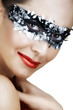 Beautiful woman with red lips and silver leaf mask