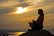 Silhouette of a beautiful woman meditating