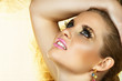 beautiful woman with fantasy golden eye make-up
