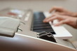 hands playing music on the piano, keyboard