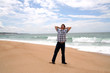 Man with his hands behind the head on the beach