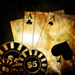 Vintage playing cards on a dark background with some poker chips