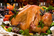 Garnished roasted turkey on holiday decorated table