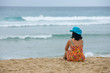 woman on the beach watching the horizon