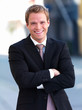 Portrait of a happy businessman smiling with hands folded