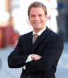 Portrait of a happy businessman smiling with hands folded