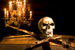 Spooky skull and sword lit by candles