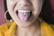 Young woman showing her pierced tongue.