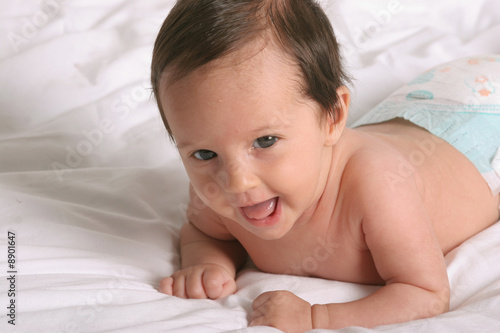 Photo: cute baby girl laying and smiling cute baby girl laying and smiling