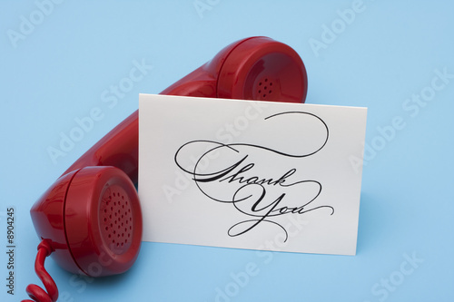 Photo: Telephone with thank you card with copy space Telephone with thank you card with copy space