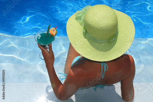 Woman lying in blue pool