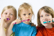 Little girl wearing colorful t-shirts brushing teeth