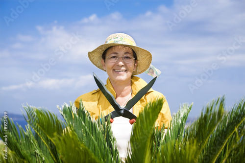 Photo: Portrait of senior Italian woman gardening Portrait of senior Italian woman gardening