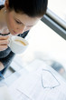 Girl drinking coffee with her eyeglasses