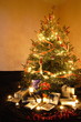 Christmas presents and candles under the tree Christmas presents and candles under the tree