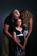 three generations of women with child being kissed