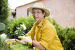 Photo: Portrait of senior Italian woman planting flowers in garden Portrait of senior Italian woman planting flowers in garden