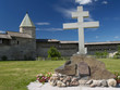 Cross and wall in Kremlin of Pskov, Russia