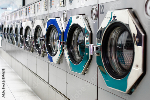 Photo: A row of laundromat washing machines A row of laundromat washing machines