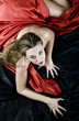 blonde girl with red silk that seeks the pleasure