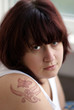 Face of young woman with tattoo on the shoulder Face of young woman with tattoo on the shoulder