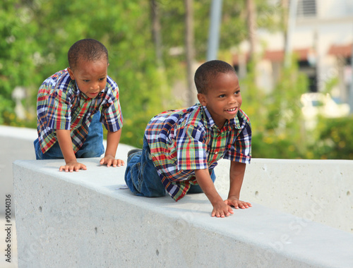 Photo: Kids crawling on a ledge Kids crawling on a ledge