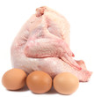 Uncooked chicken and three brown eggs.
