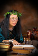 Photo: Halloween witch reading in her book of shadows Halloween witch reading in her book of shadows