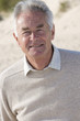 Portrait of senior man standing on beach