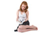 A young girl sits and reads a book