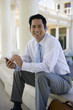 Businessman using hands-free device outdoors