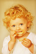 Photo: A little girl eating a biscuit A little girl eating a biscuit