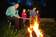 A family sitting at campfire