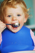 Photo: A little girl eating her meal A little girl eating her meal