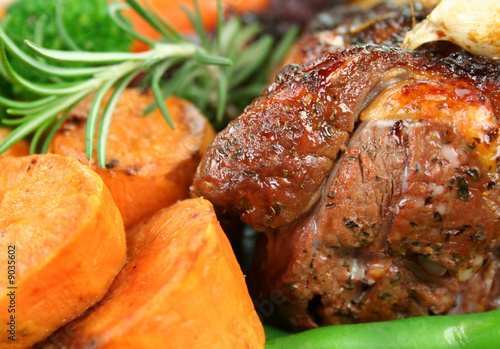 Roast lamb with garlic, carrots, beans and pumpkin.