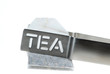 Teabag with teaspoon isolated on white