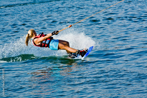 Photo: young woman skiing on lake, summer day young woman skiing on lake, summer day
