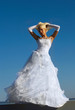 Photo: Blonde bride on blue sky background Blonde bride on blue sky background