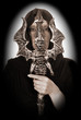 Female Halloween sorcerer, magician with ritual sword.