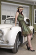 Photo: Beautiful woman leaning on a classic Jaguar car Beautiful woman leaning on a classic Jaguar car