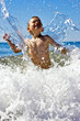 young child playing in the waves