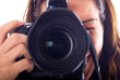 Young woman with digital camera taking picture