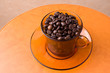 Coffee beans in a cup on a table Coffee beans in a cup on a table